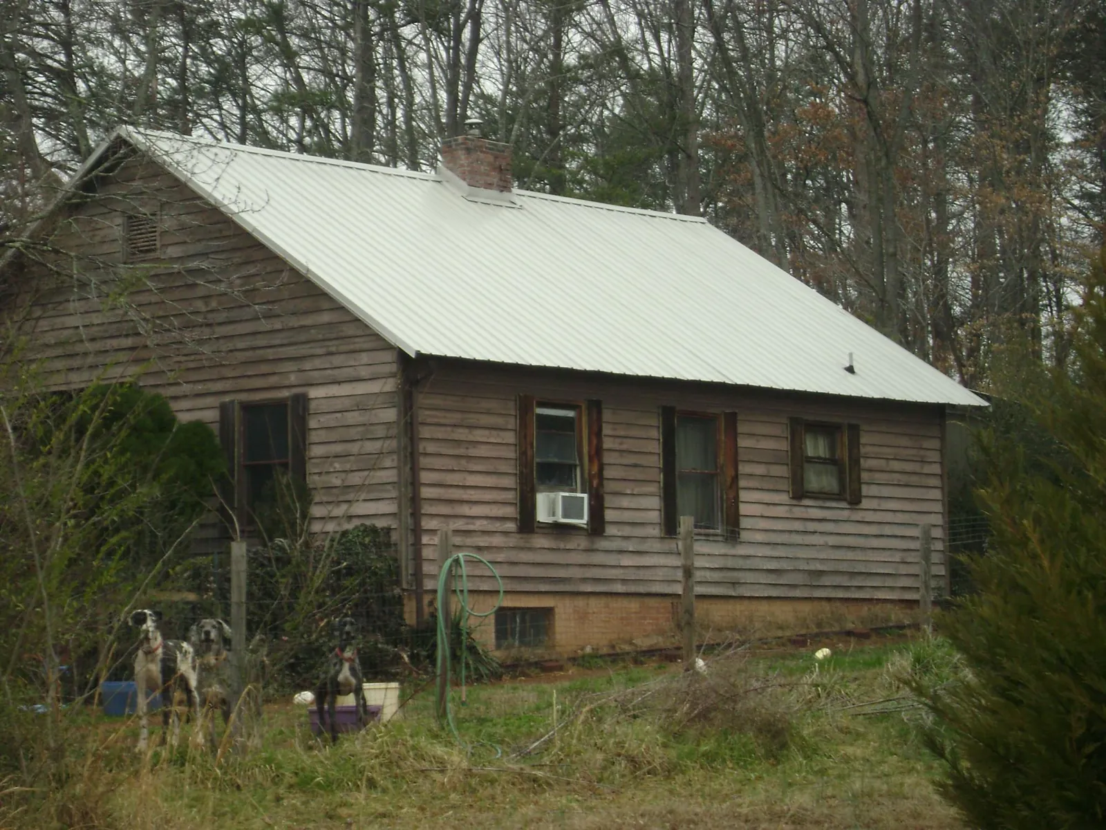 White metal roof on an old wood sided farmhouse, from a Metal Roof Installation job in Myrtle Beach